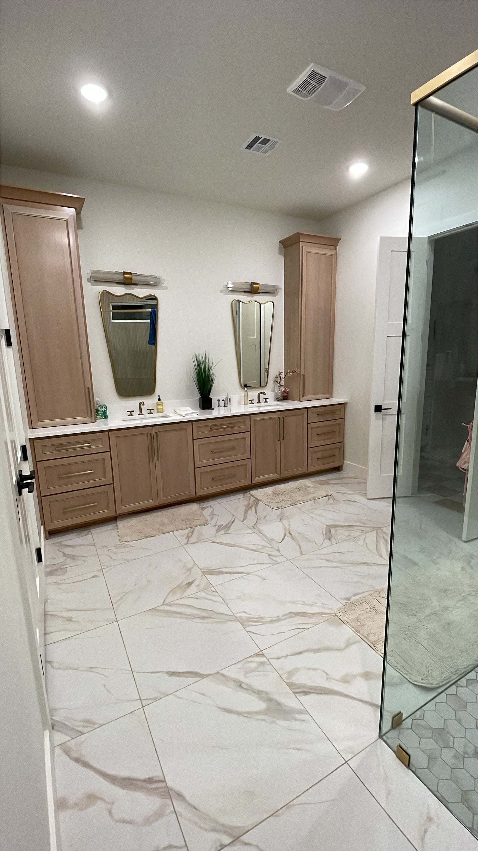 Custom double vanity with tower cabinets built by LKP Woodworks in a primary bathroom