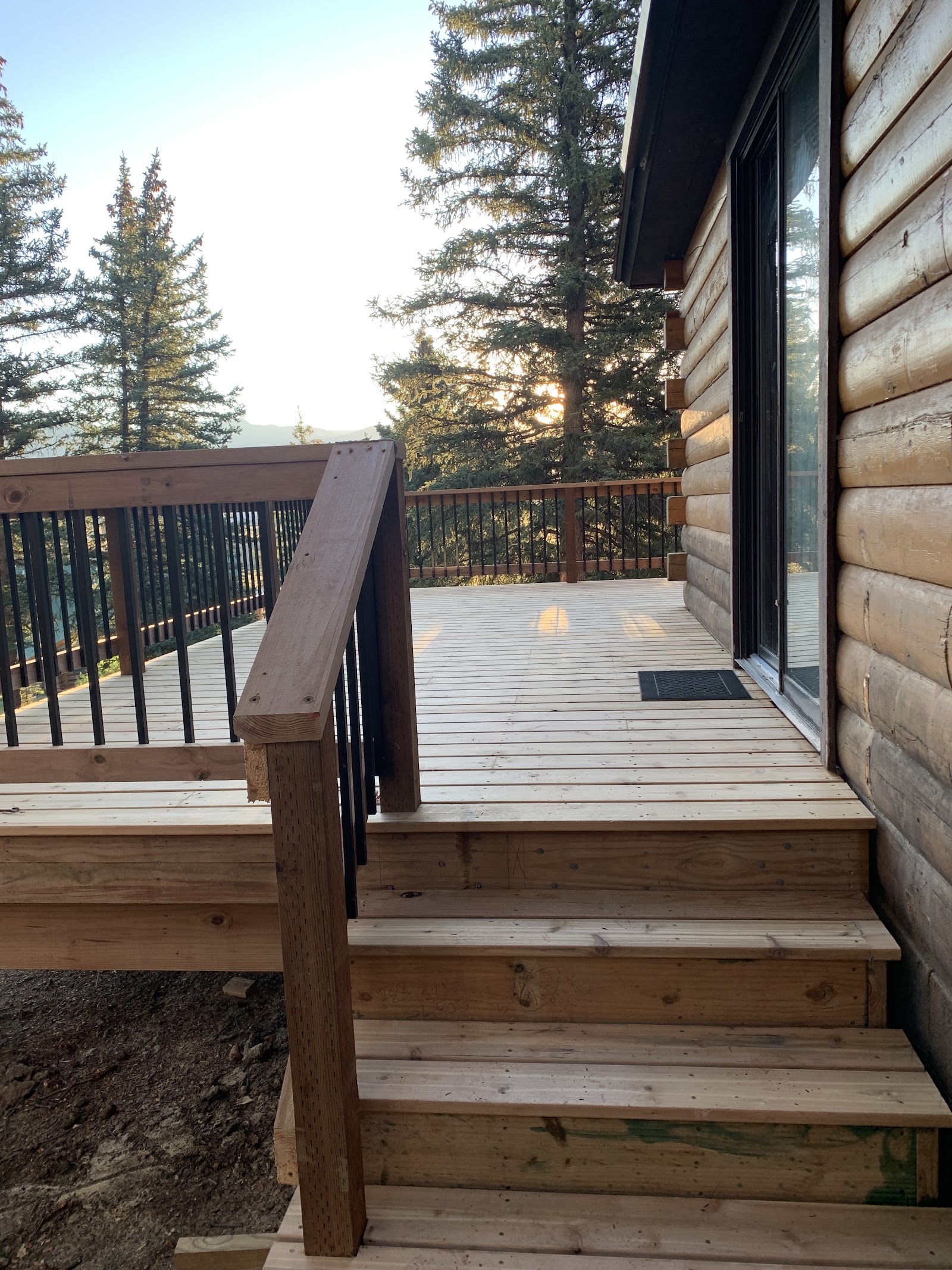 New deck stairs with wood handrail and metal balusters built by LKP Woodworks
