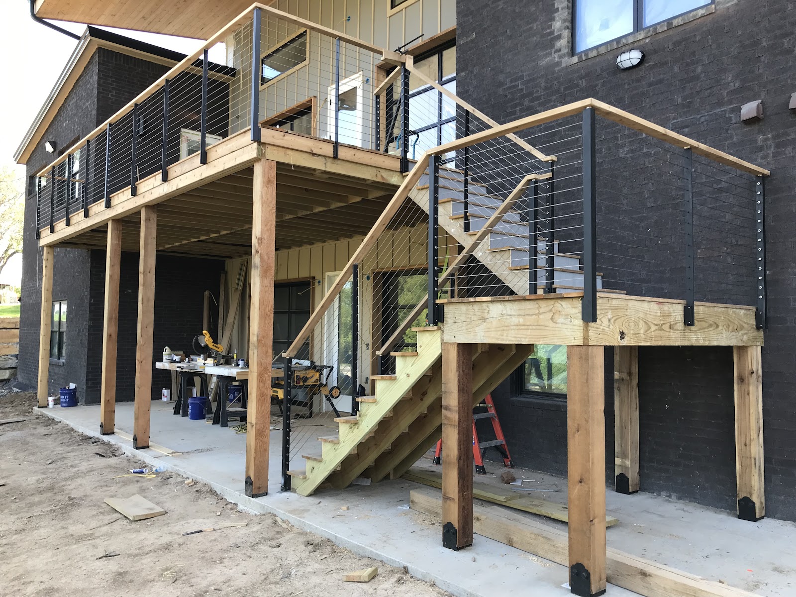 Elevated deck and staircase with cable railing built by LKP Woodworks on a modern Tulsa area home