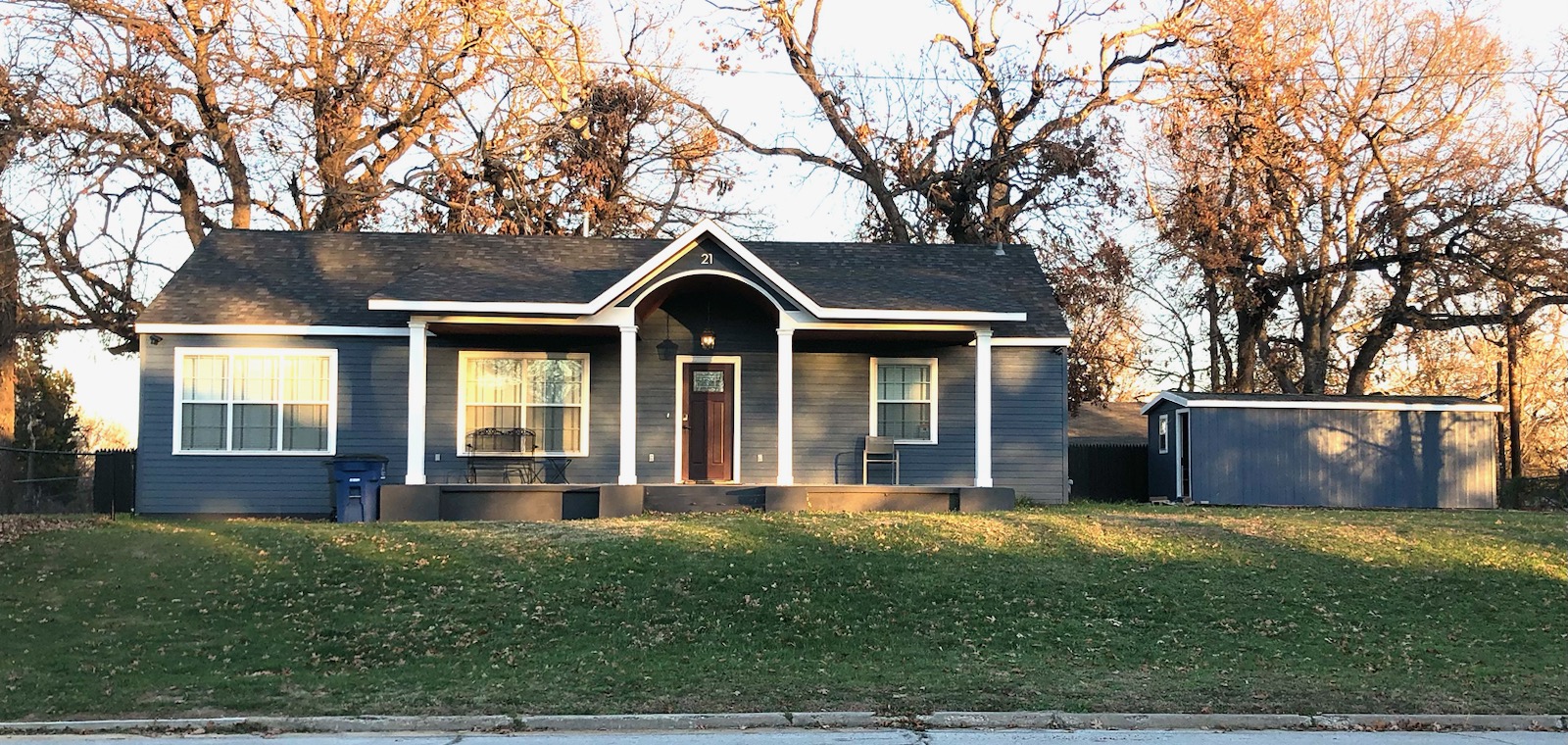 Finished front porch with arched ceiling built by LKP Woodworks on a Claremore area home